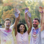 friends-posing-while-holding-colored-hands-air